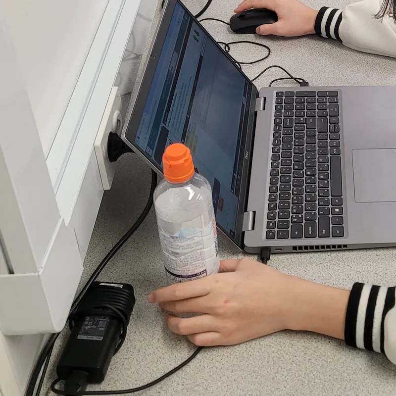 Teenagers coding on laptop and desktop computers