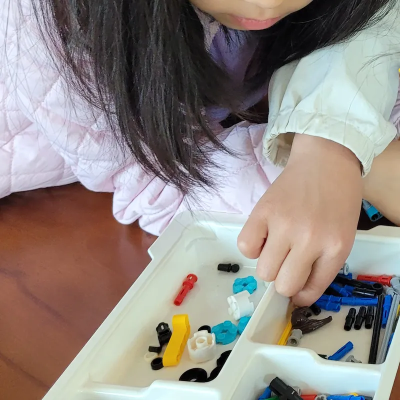 Children assembling LEGO robots and creating a game in Scratch
